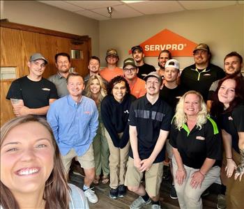 Employees by SERVPRO sign.